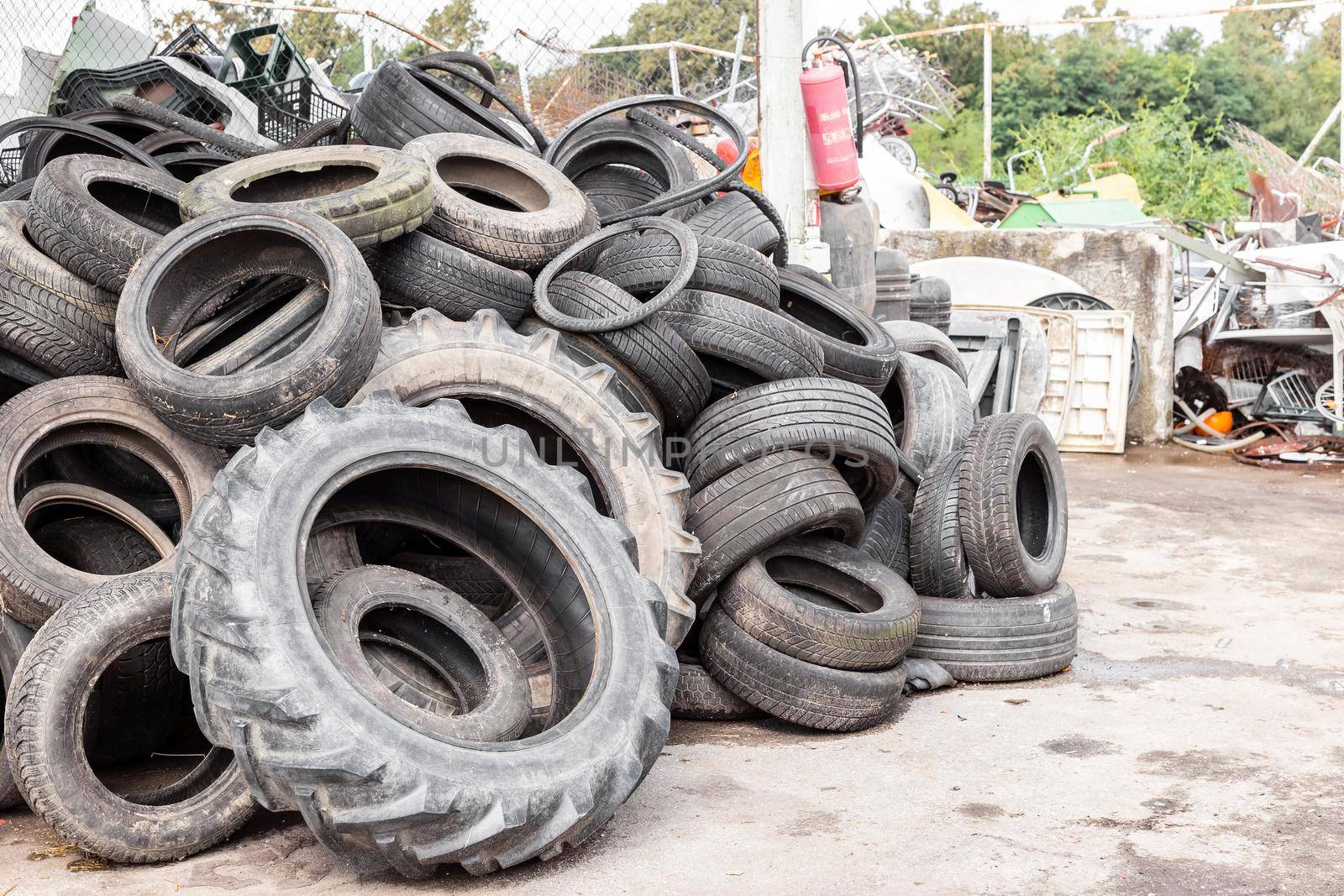 City dump with old tires and tyres for recycling. Recycling of the waste rubber tyres. Disposal of worn out wheels for recycling.