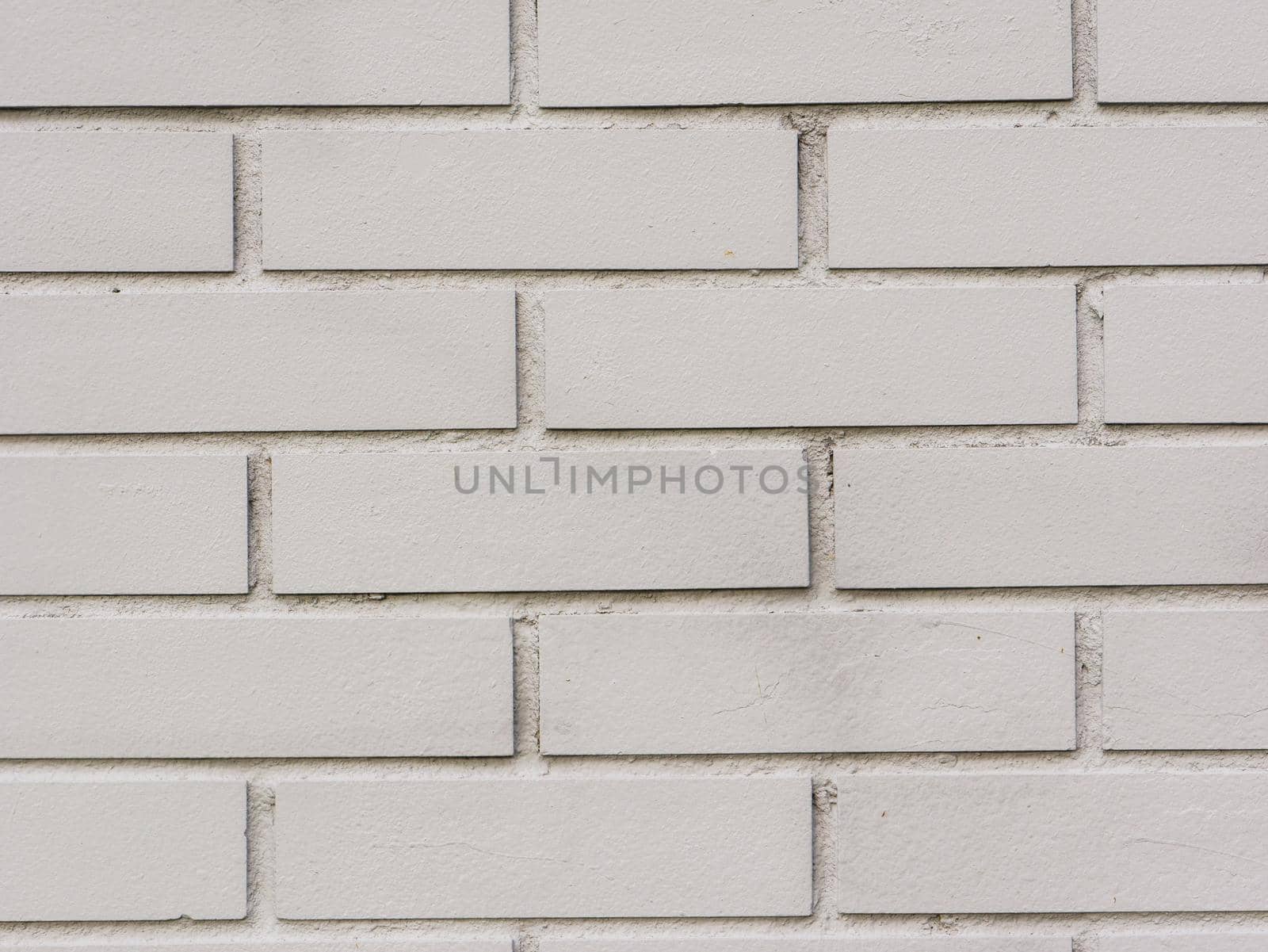 Abstract background of a gray brick wall close-up.