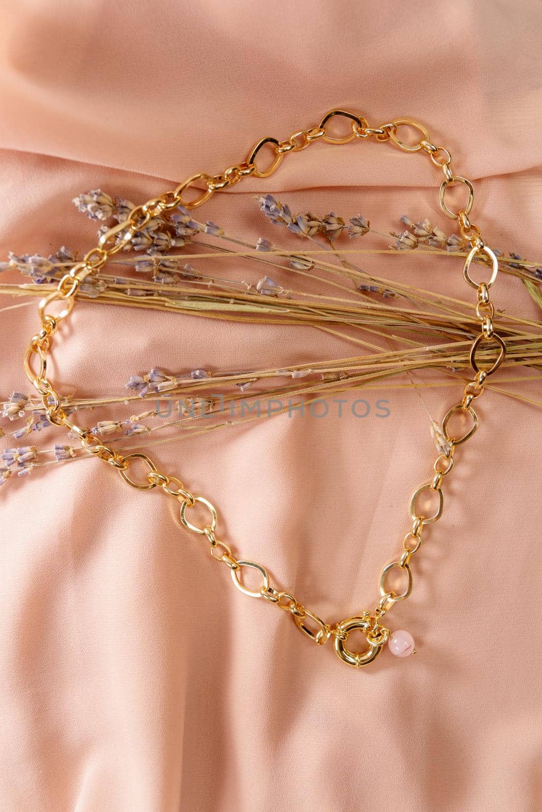 Gold chain natural mixed pink rose quartz necklace. Vertical photo