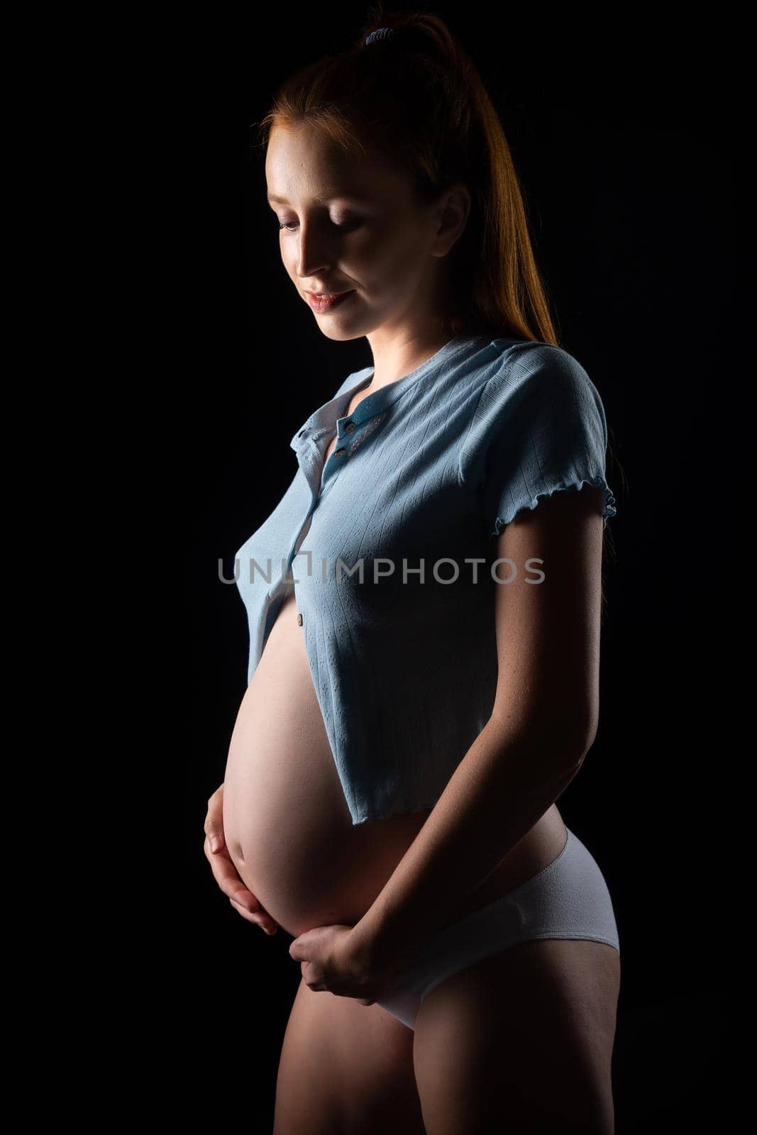 A pregnant woman with a big belly and red hair. by Evgenii_Leontev