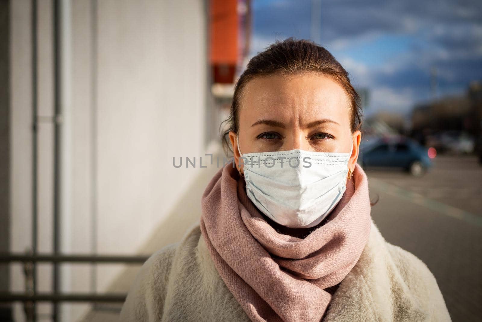 A picture of a girl in a mask. On the street. isolated Covid-19 pandemic.