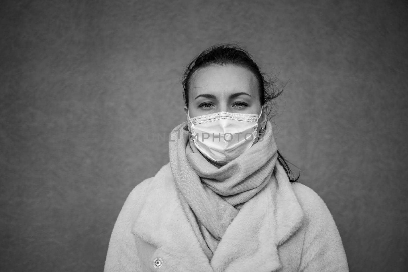 A picture of a girl in a mask. On the street. isolated Covid-19 pandemic.