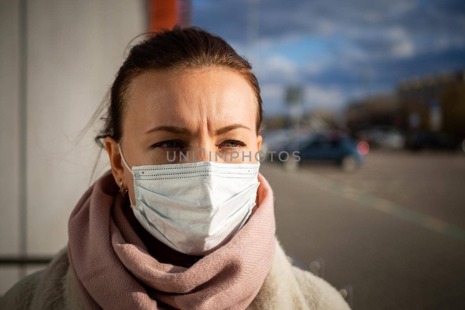 A picture of a girl in a mask. On the street. isolated Covid-19 pandemic.