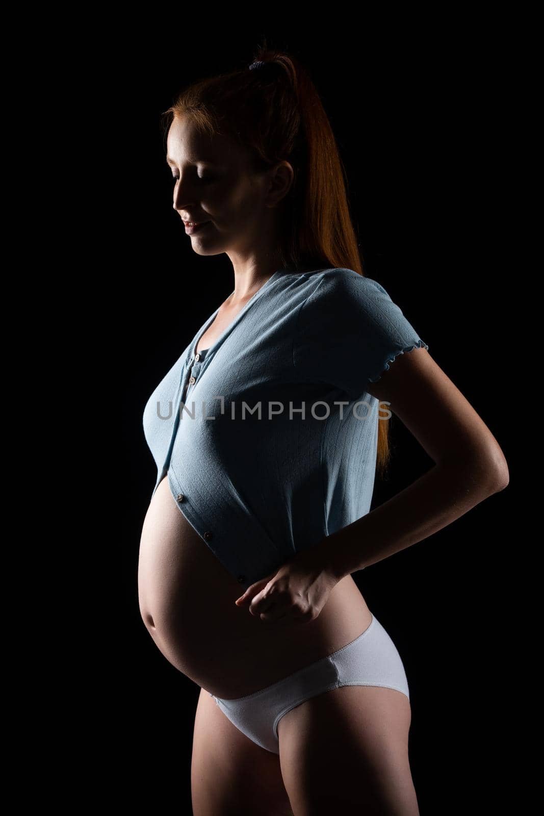 A pregnant woman with a big belly and red hair. by Evgenii_Leontev