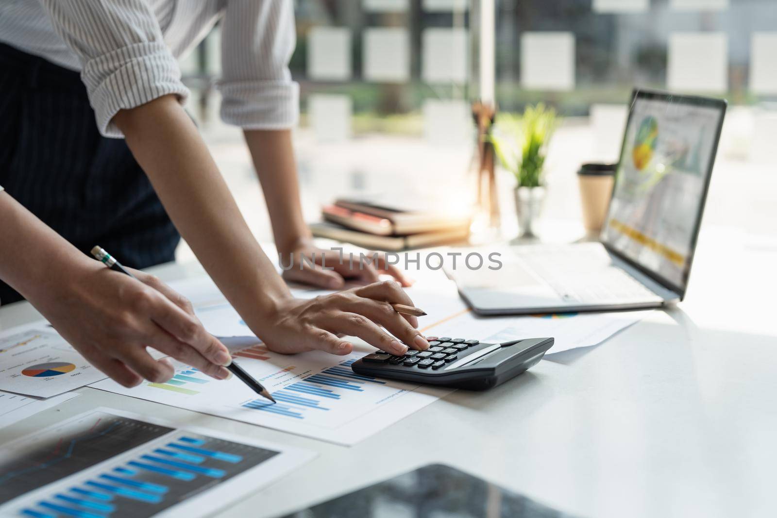 Close up accountant bookkeeper woman working about financial with calculator at his office to calculate expenses, Accounting concept.