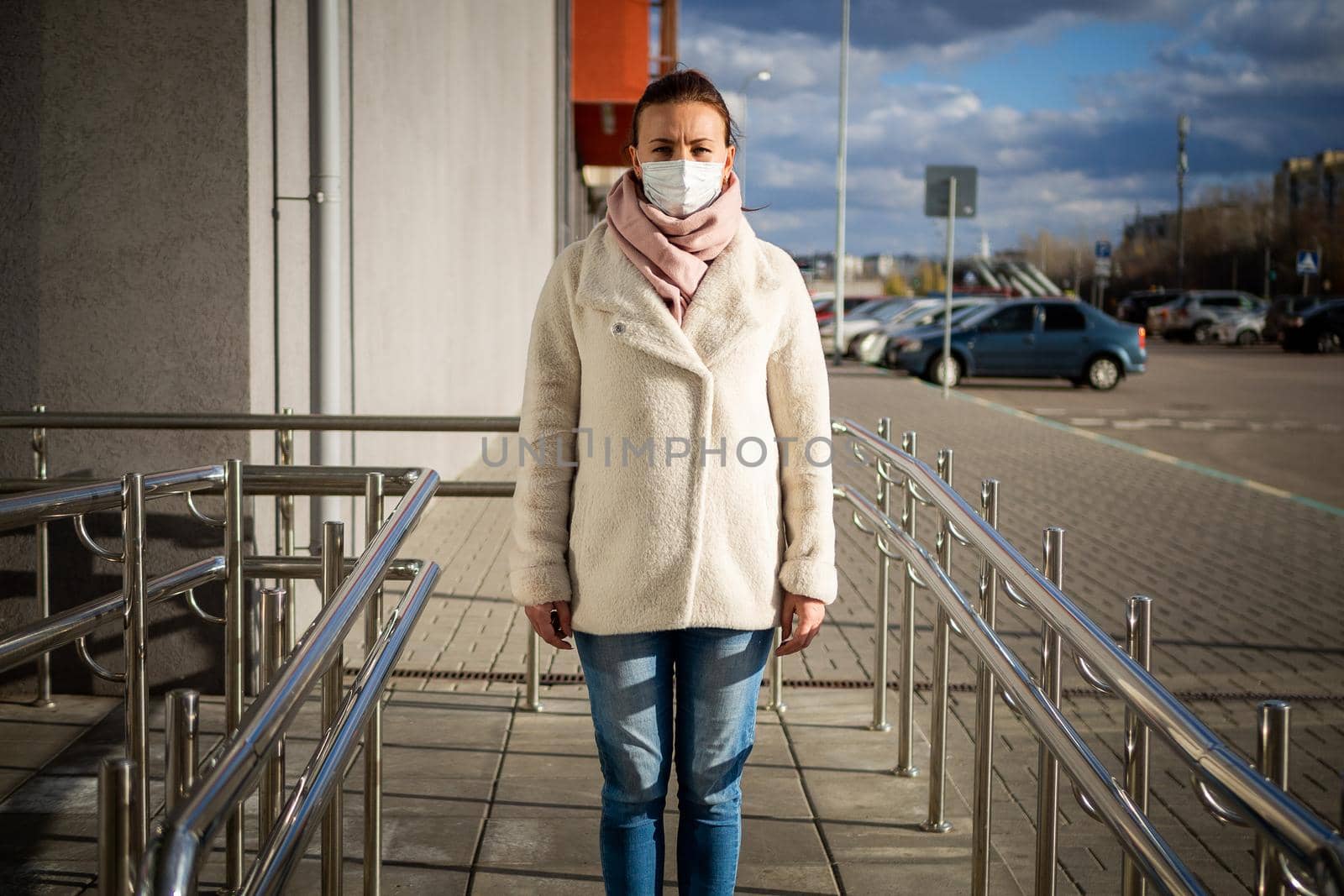 A picture of a girl in a mask. On the street. isolated Covid-19 pandemic.