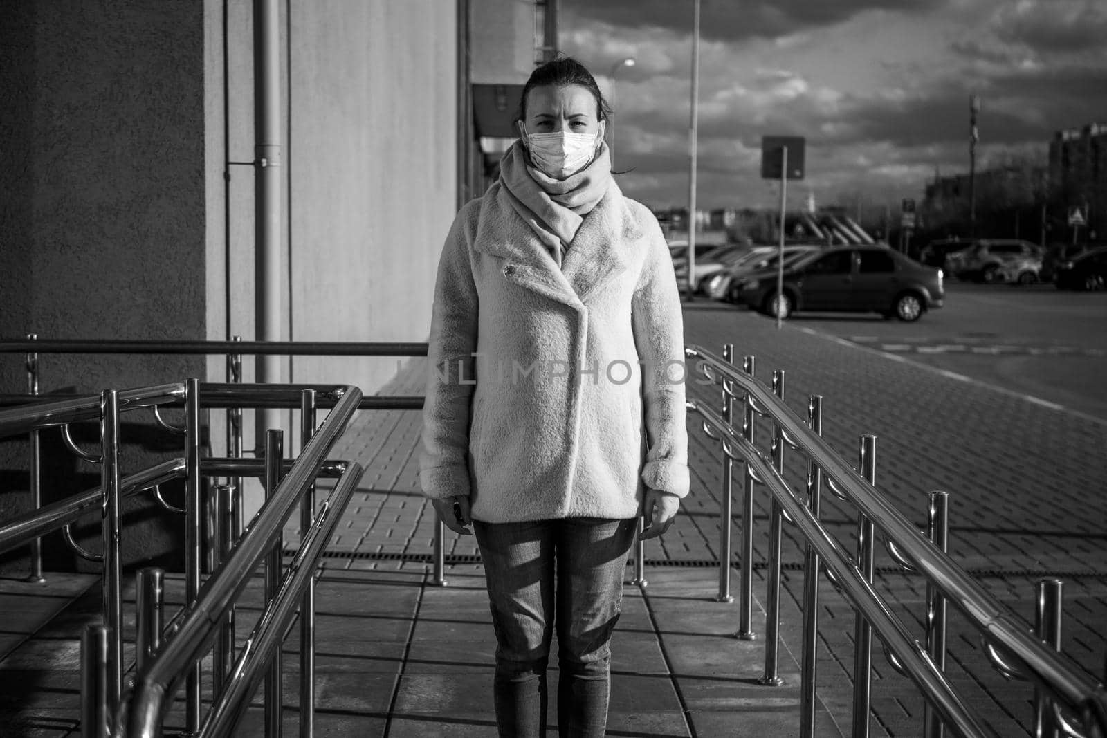 A picture of a girl in a mask. On the street. isolated Covid-19 pandemic.