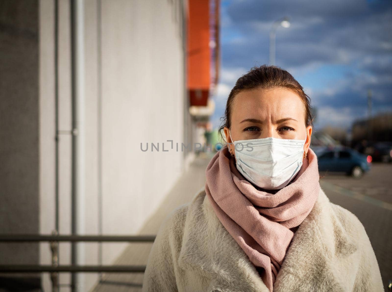 A picture of a girl in a mask. On the street. isolated Covid-19 pandemic.