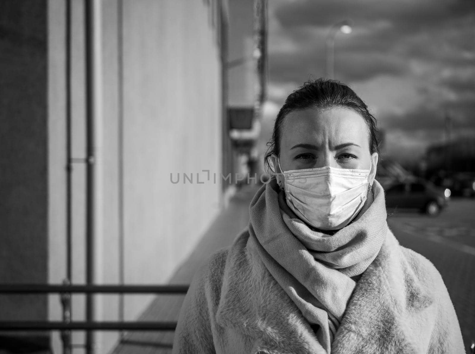 A picture of a girl in a mask. On the street. isolated Covid-19 pandemic.