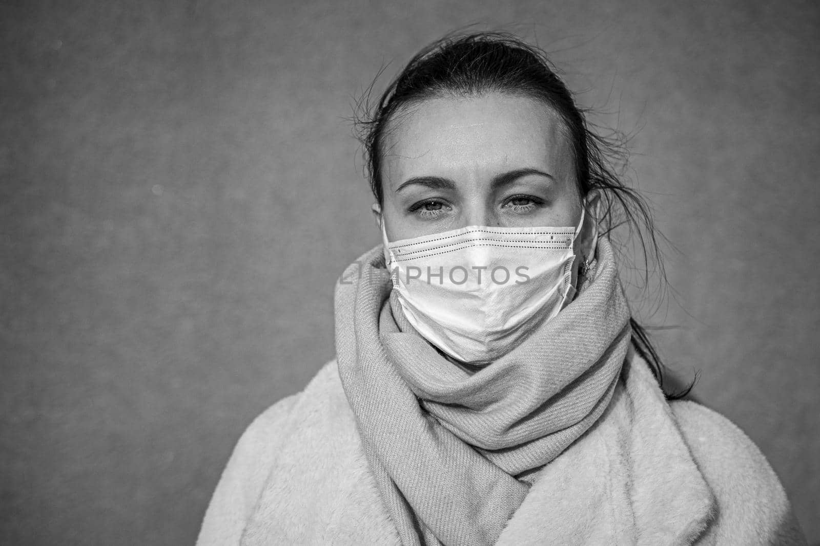 A picture of a girl in a mask. On the street. isolated Covid-19 pandemic.