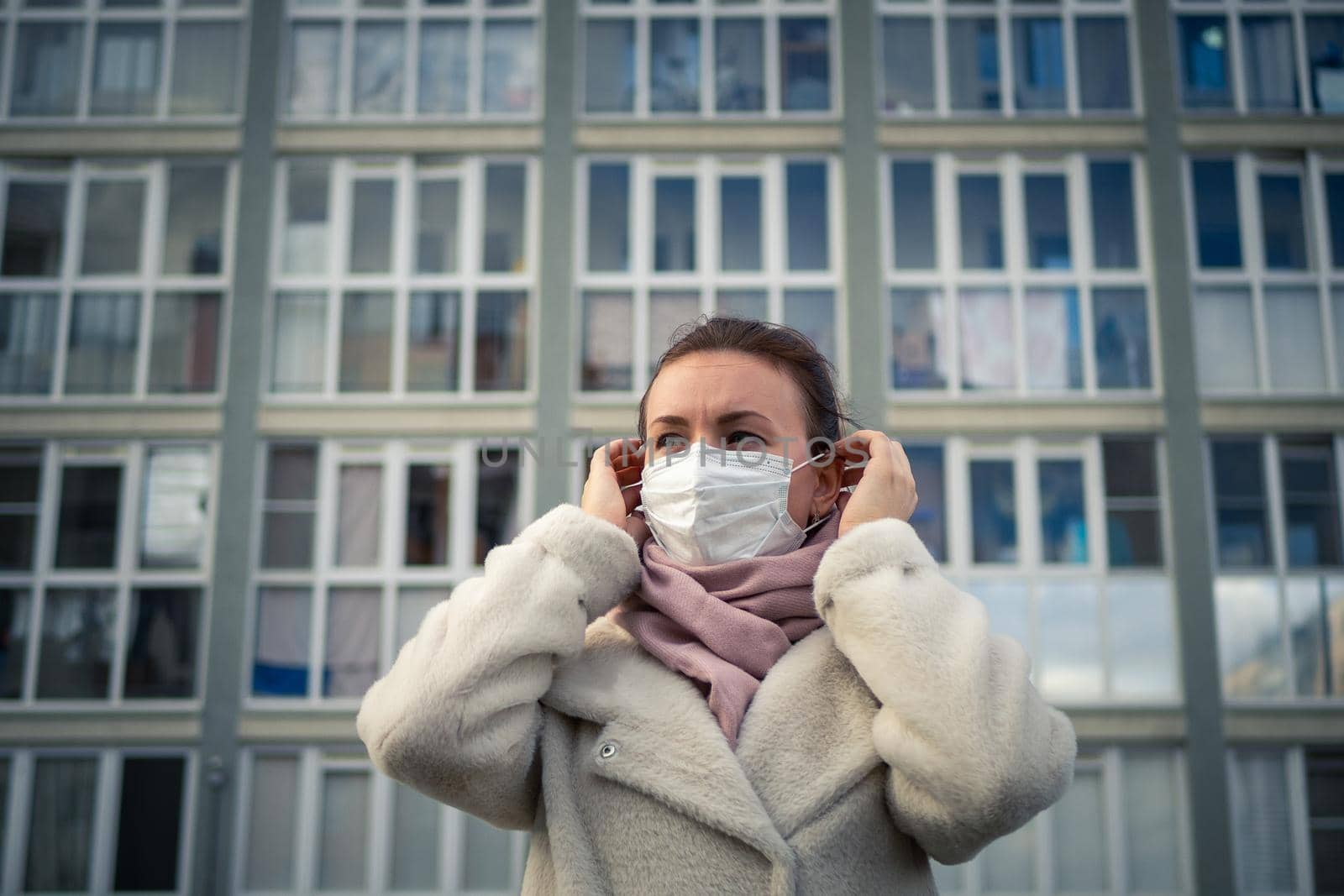 Shot of a girl in a mask, on the street. lockdown Covid-19 pandemic. by Evgenii_Leontev