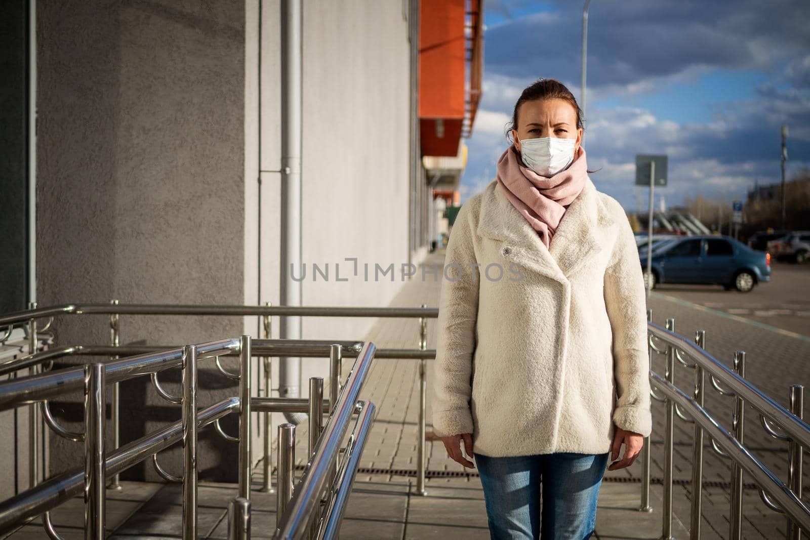 A picture of a girl in a mask. On the street. isolated Covid-19 pandemic.