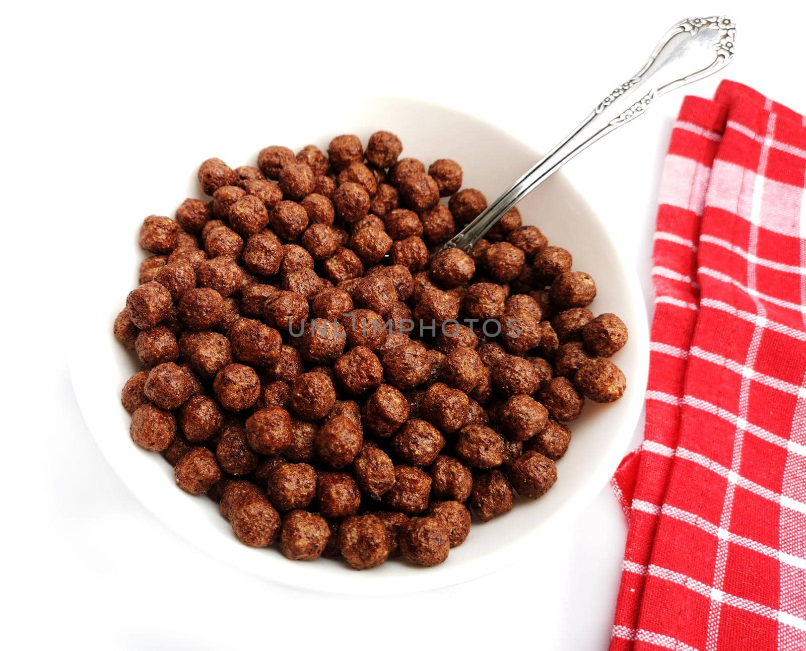 Bowl with chocolate corn balls on a table