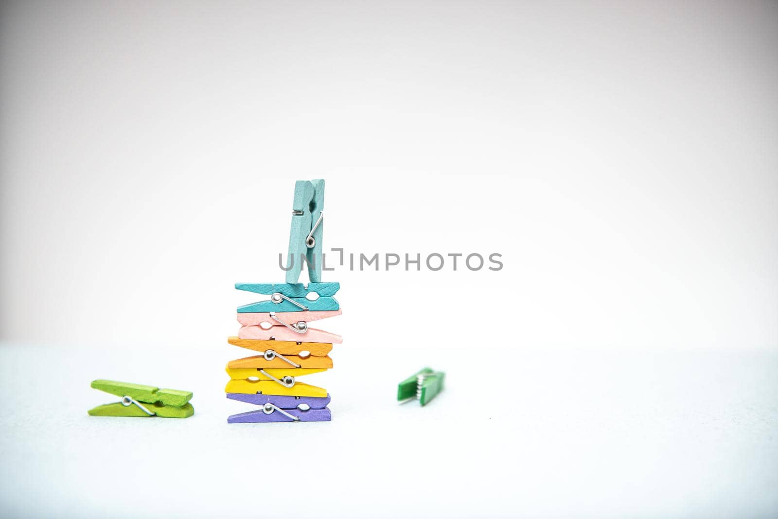 multi-colored clothespins for laundry on a white background by marynkin