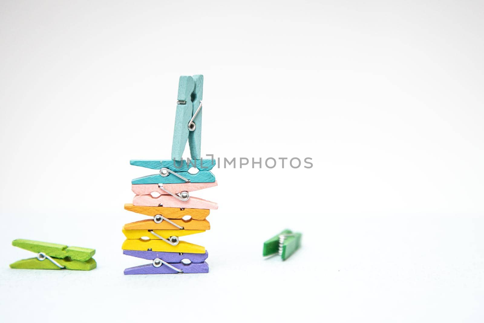 multi-colored clothespins for laundry on a white background by marynkin