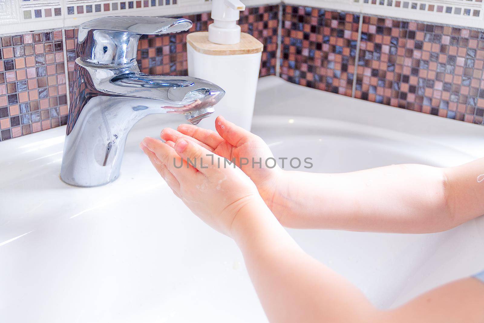 Close up hands of children Washing hands with soap under the faucet with water. clean and Hygiene concept