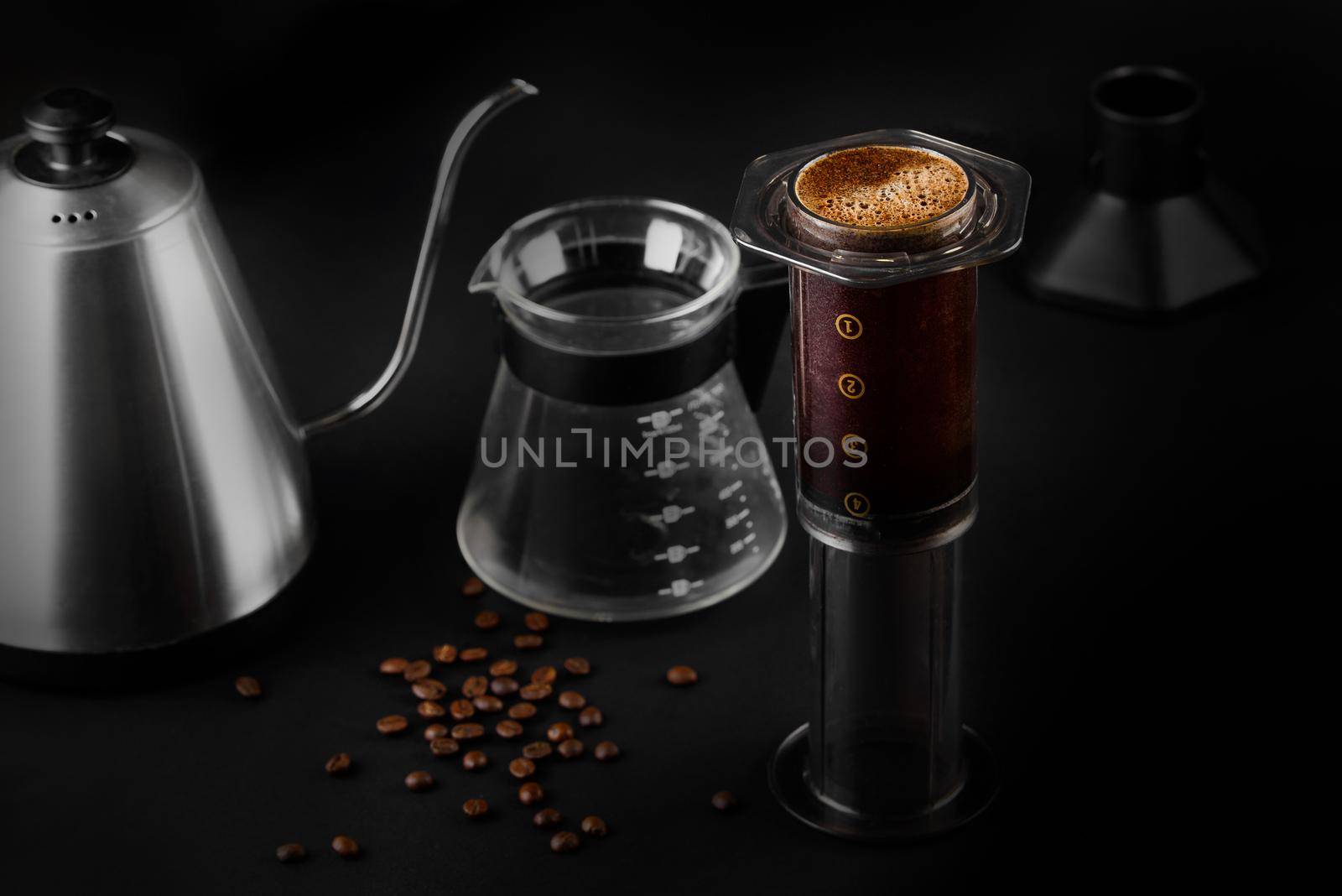 AeroPress on black background .The AeroPress is a device for brewing coffee. Coffee brewing.