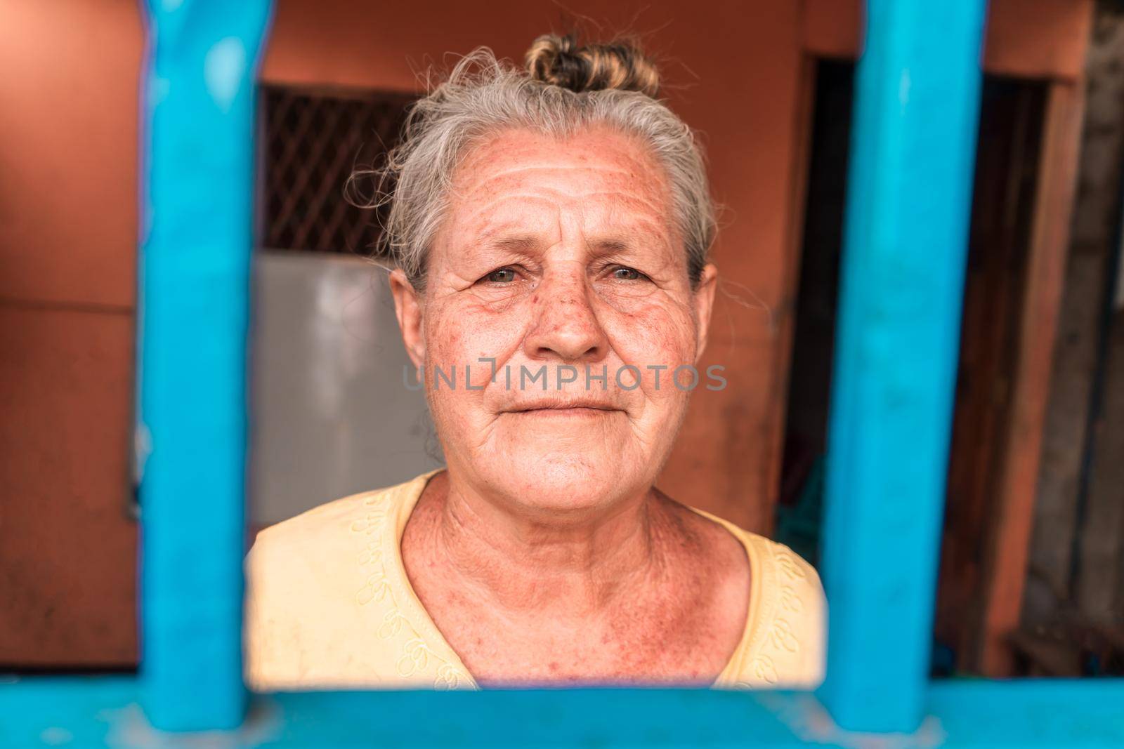 Elderly white latin woman with blue eyes at home looking at camera by cfalvarez