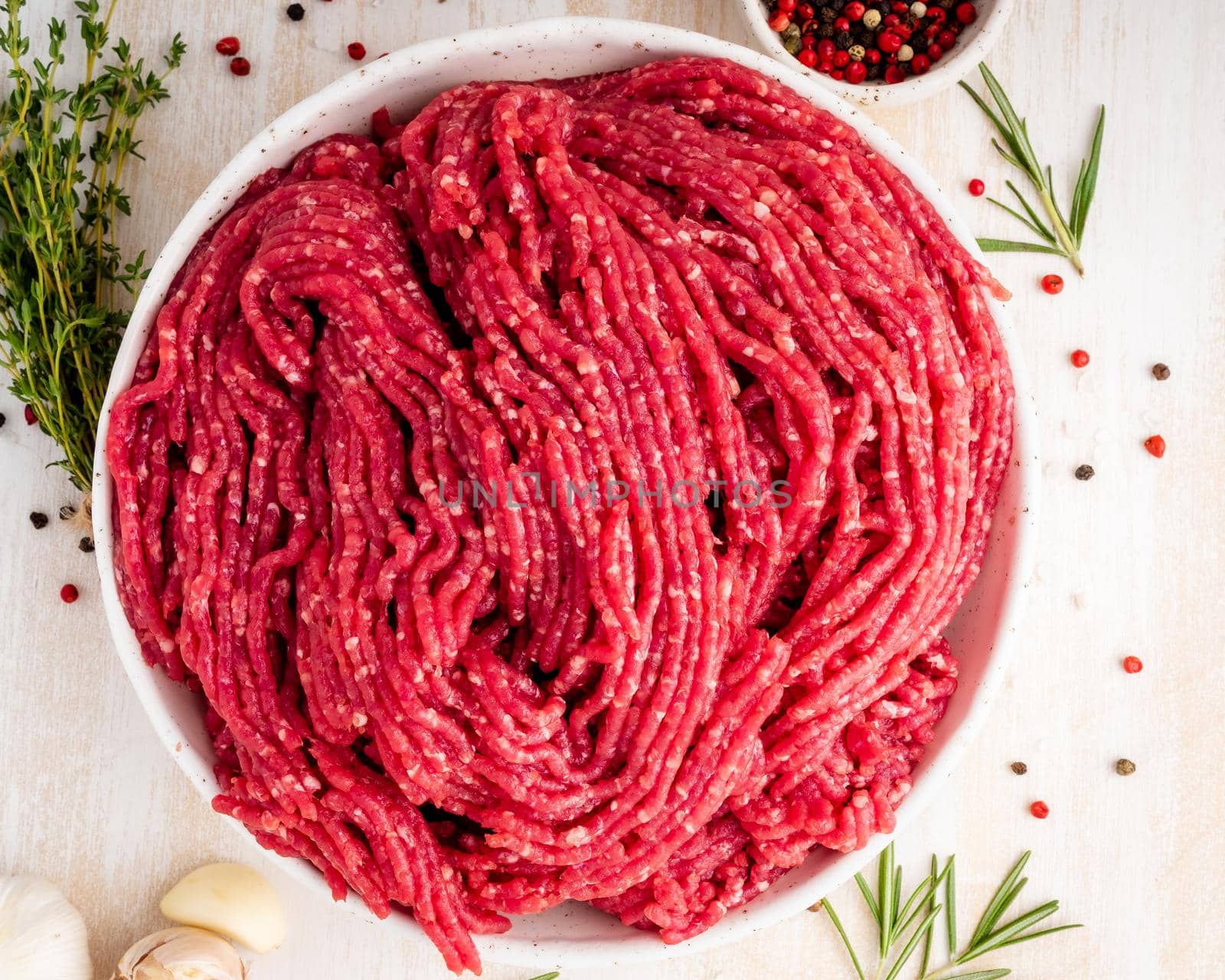 Mince beef, ground meat with ingredients for cooking on dark blue by NataBene