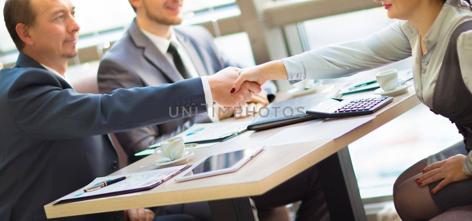 Business handshake. Handshake of two business men closing a deal at the office by SmartPhotoLab