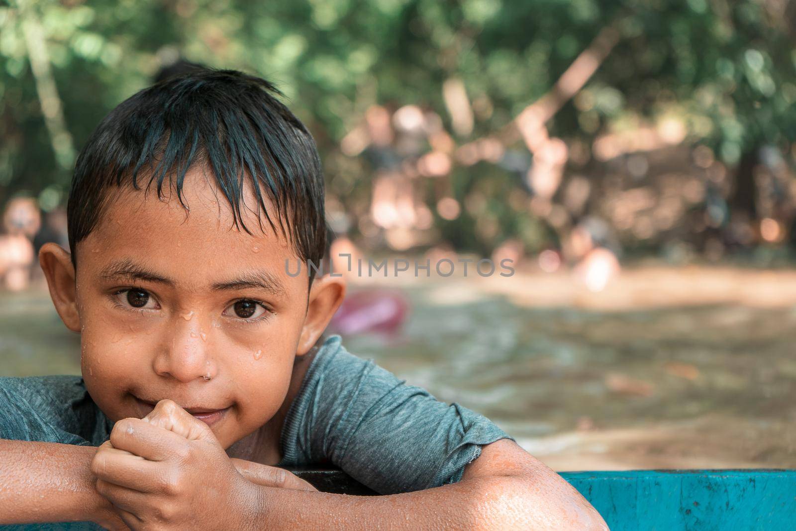 Portrait of a Latin boy enjoying a summer afternoon at a river dam by cfalvarez