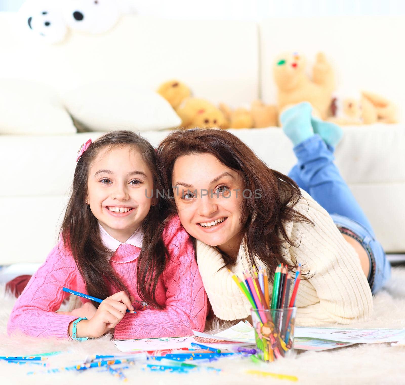 Beautiful girl draws with his mother