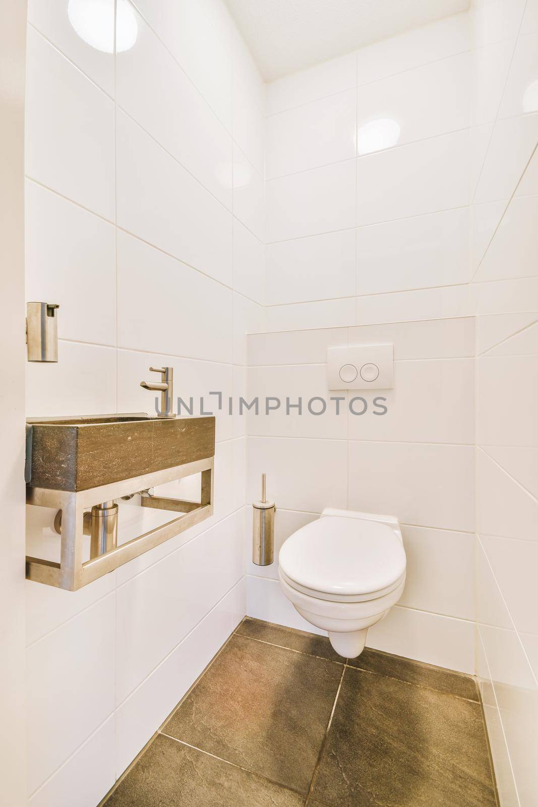 Small toilet room with tiled wall and sink