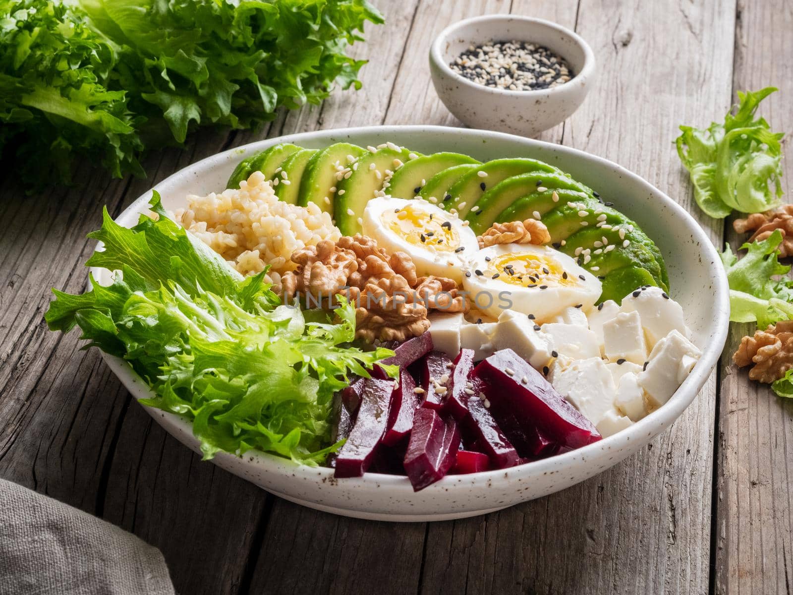 Buddha bowl, balanced food, vegetarian menu. Eggs, avocado, salad lettuce, bulgur by NataBene