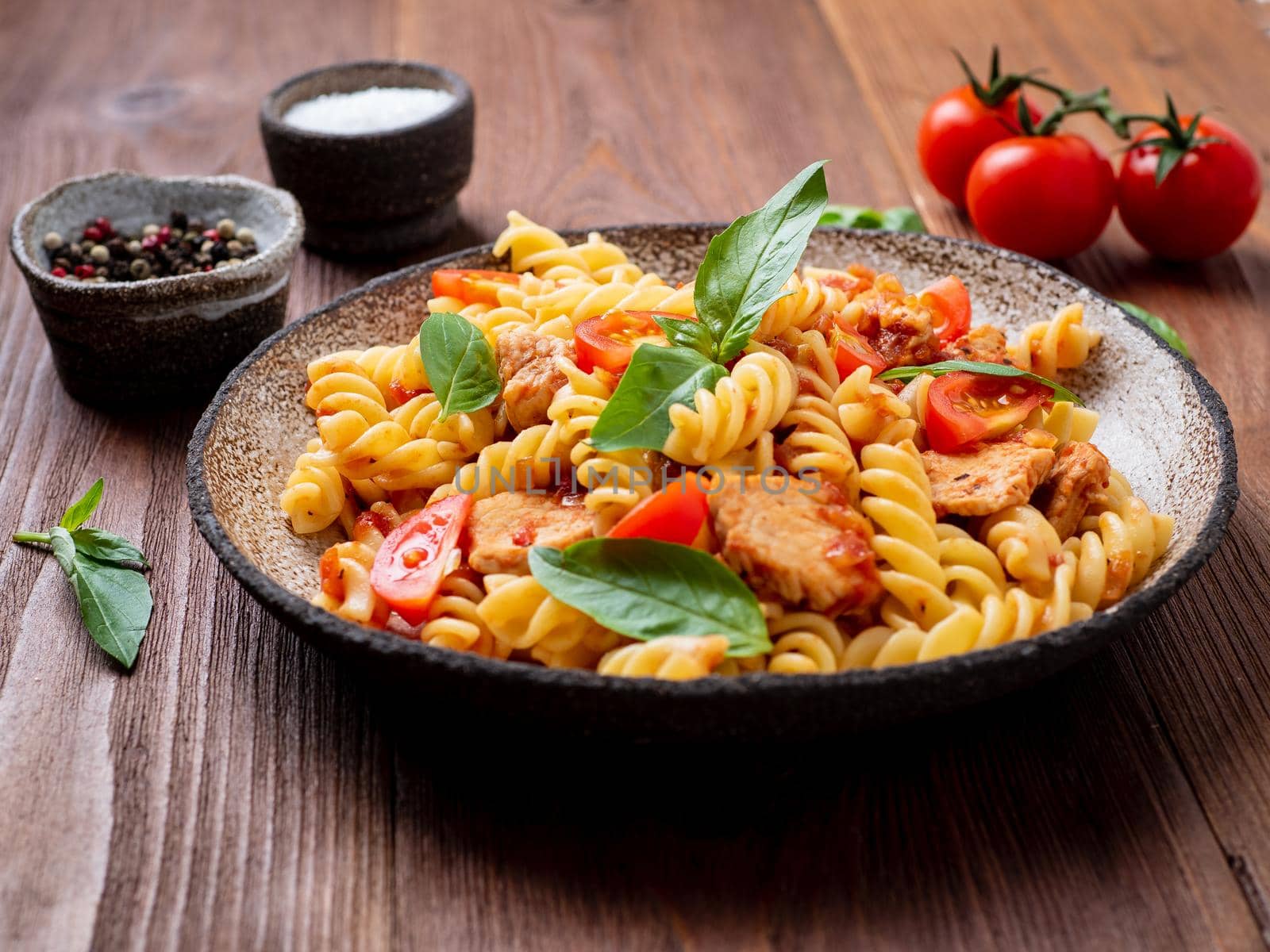 fusilli pasta with tomato sauce, chicken fillet with basil leaves by NataBene