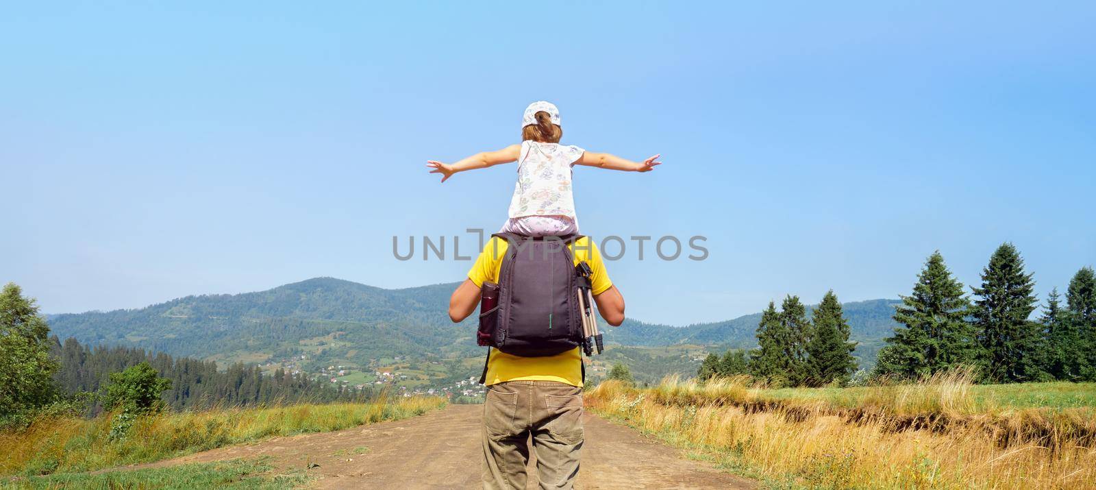 Freedom mountain children hiking trail walking hills. Piggyback ride father child travel mountain kids freedom child on shoulders dad and daughter father walking hiking trip nature kid arms spread out