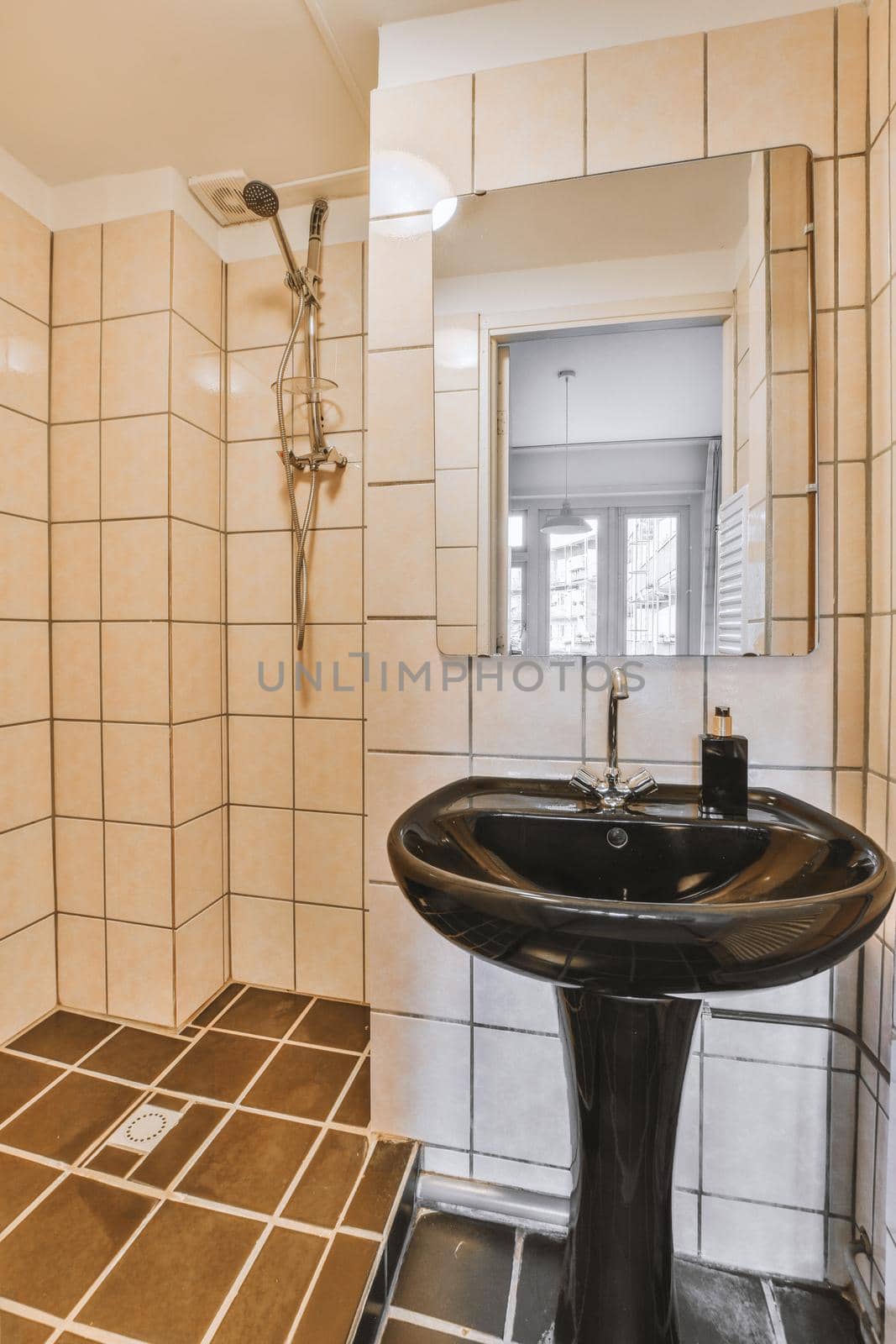 The interior of a cozy bathroom with beige tiles by casamedia