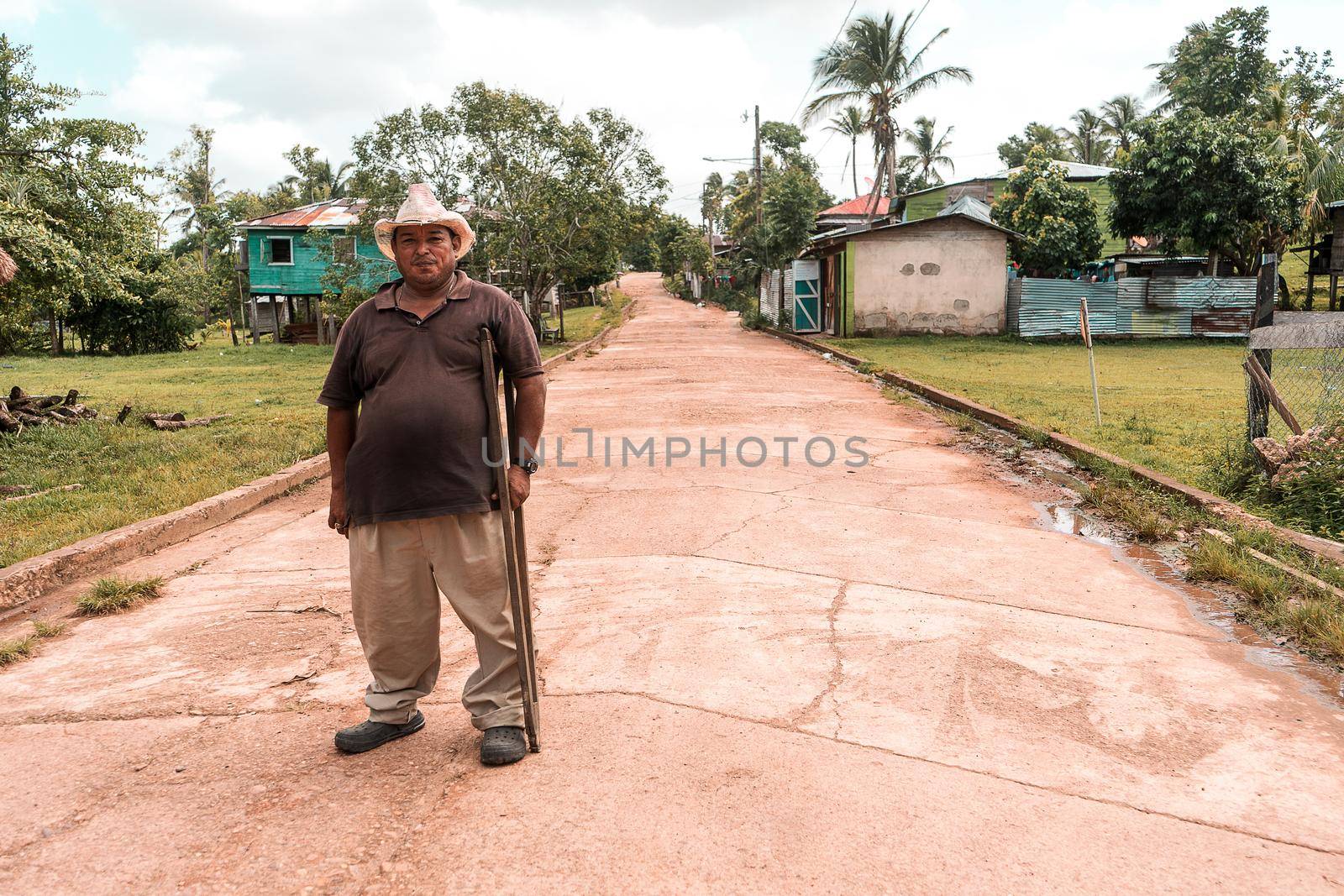 Mestizo indigenous man with crutches and hat in the caribbean of Nicaragua. Lifestyle concept of rural communities in Latin America.