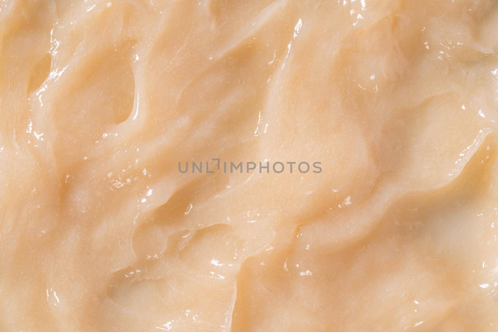 Hair conditioner cream background. Yellow cosmetic lotion moisturiser sample closeup. Body care balm, retinol serum, shampoo wavy texture. Skincare mask smear, creamy cleanser product by photolime