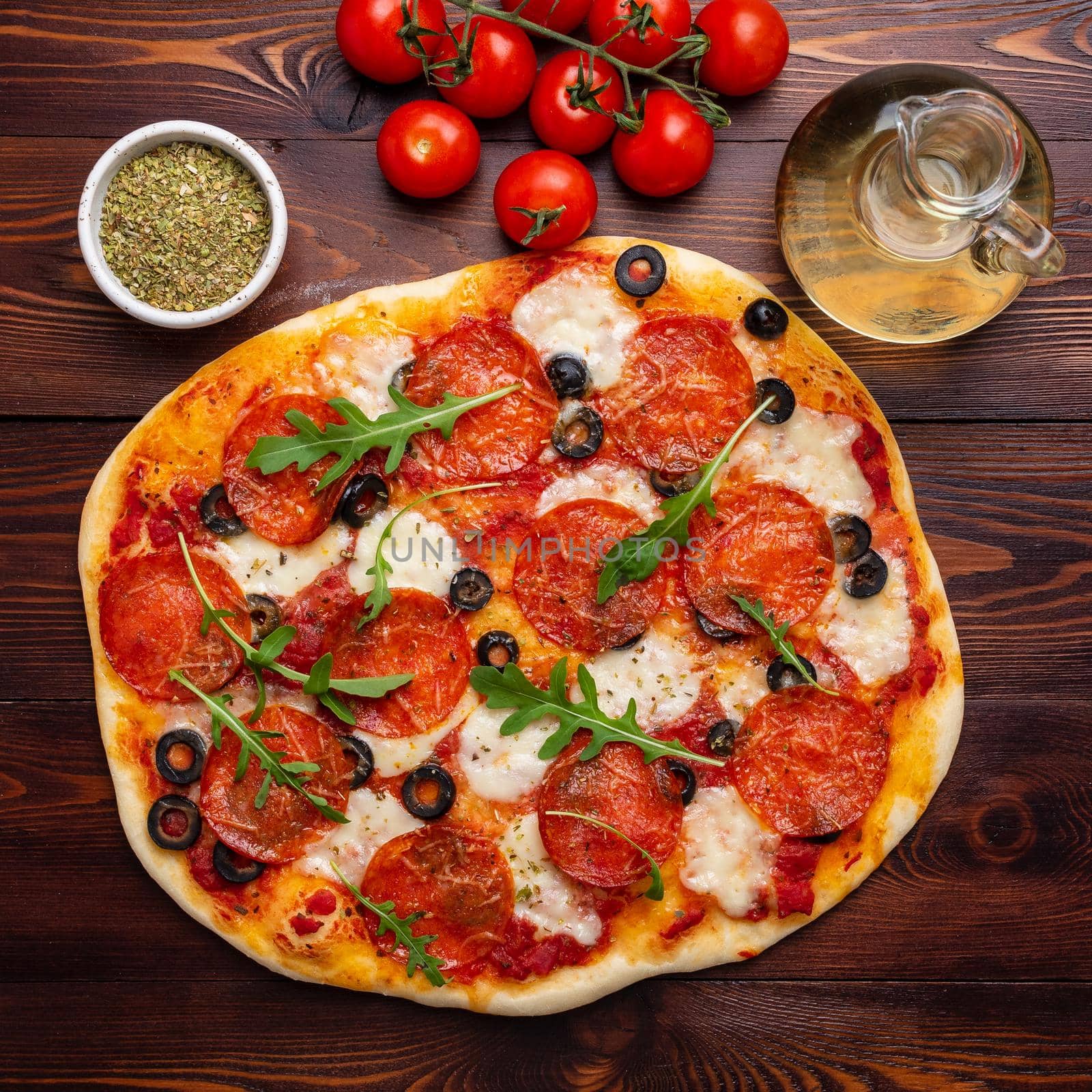 hot homemade Italian pepperoni pizza with salami, mozzarella and olives by NataBene
