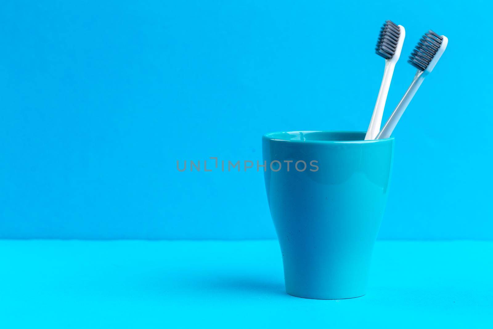 Toothbrushes in glass on the table
