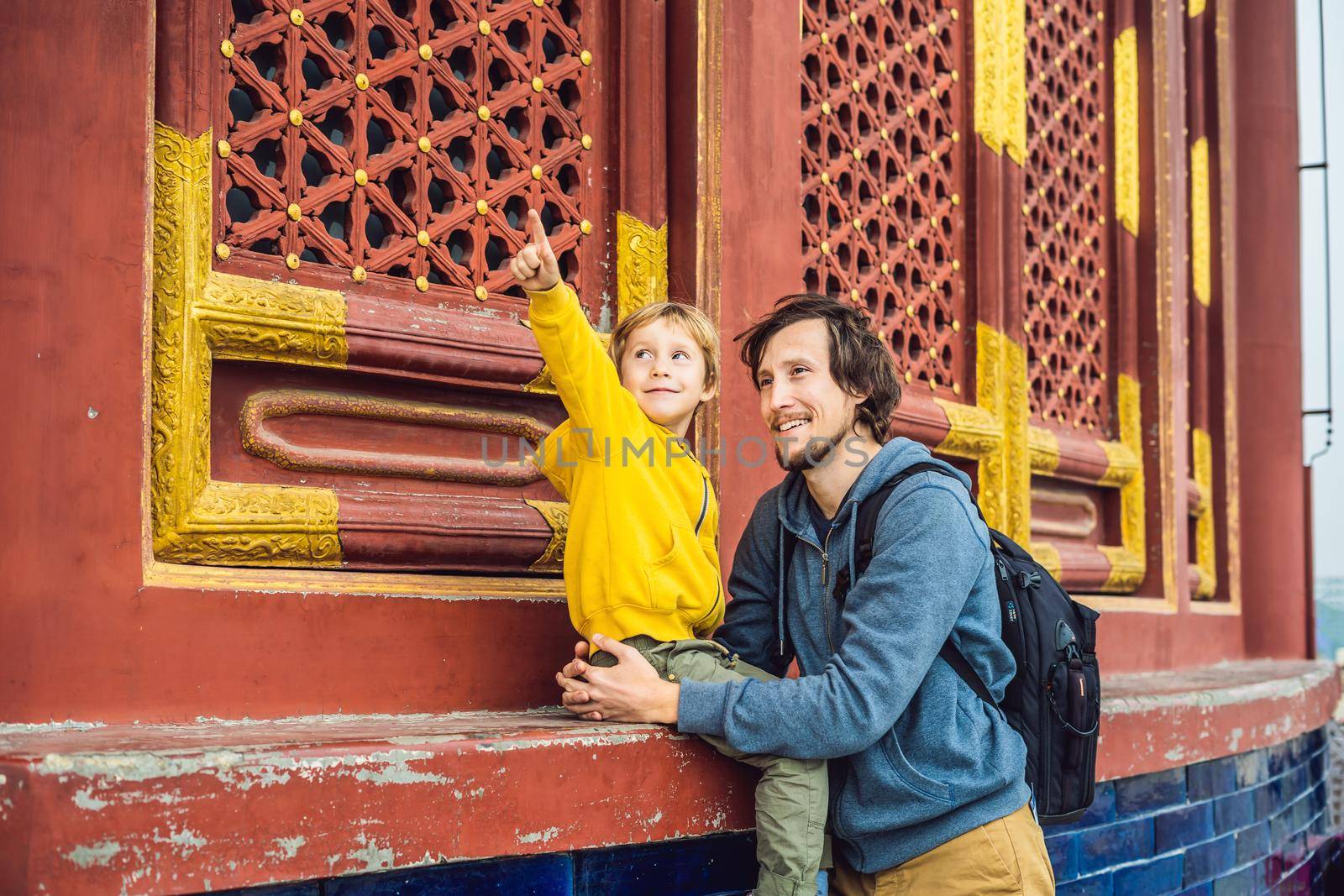 Dad and son travelers in the Temple of Heaven in Beijing. One of the main attractions of Beijing. Traveling with family and kids in China concept by galitskaya