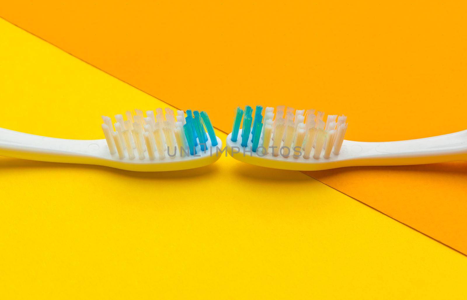 Flat lay composition with manual toothbrushes on color background, close up by Fabrikasimf