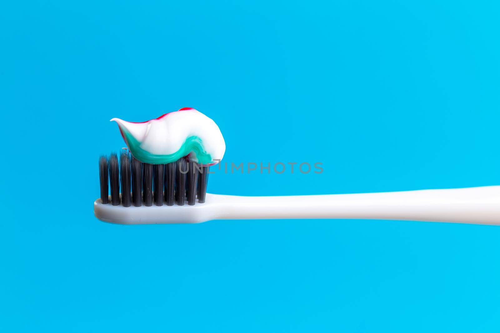 Toothbrush and toothpaste on blue. creative photo by Fabrikasimf