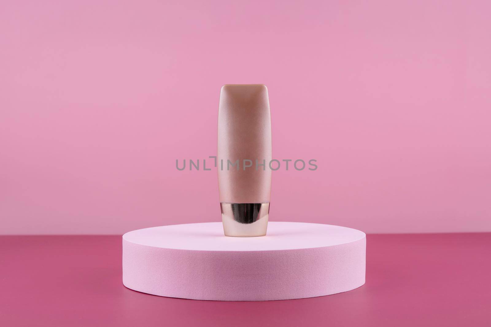 Beige concealer base cosmetics product mock up on pink background. Cosmetic liquid foundation nude cream bottle mockup on round podium pedestal. Skincare beauty primer, bb cc corrector