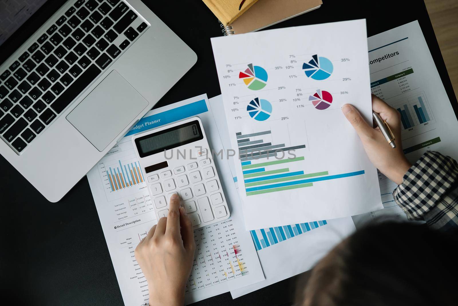 Close up Businessman using calculator and laptop for calculating finance, tax, accounting, statistics and analytic research concept.