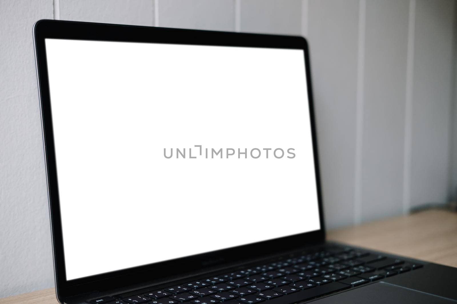 Computer mockup white background on table. Laptop with blank screen.