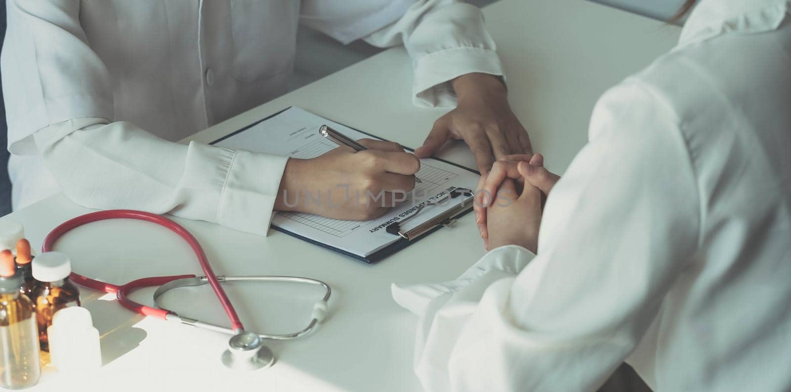 doctor holding test results and consulting patient at desk medical office, Hospital clinic healthcare professionalism concept.