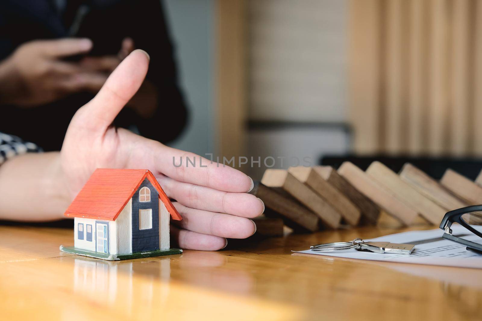Protect the house from falling over the wooden blocks, Insurance and risk concept