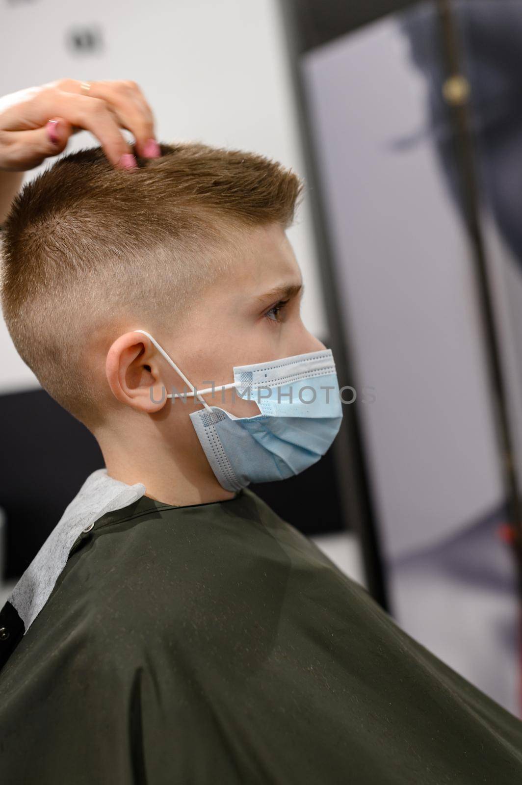 Schoolboy in a barbershop during a pandemic, stylish haircut for baby. by Niko_Cingaryuk