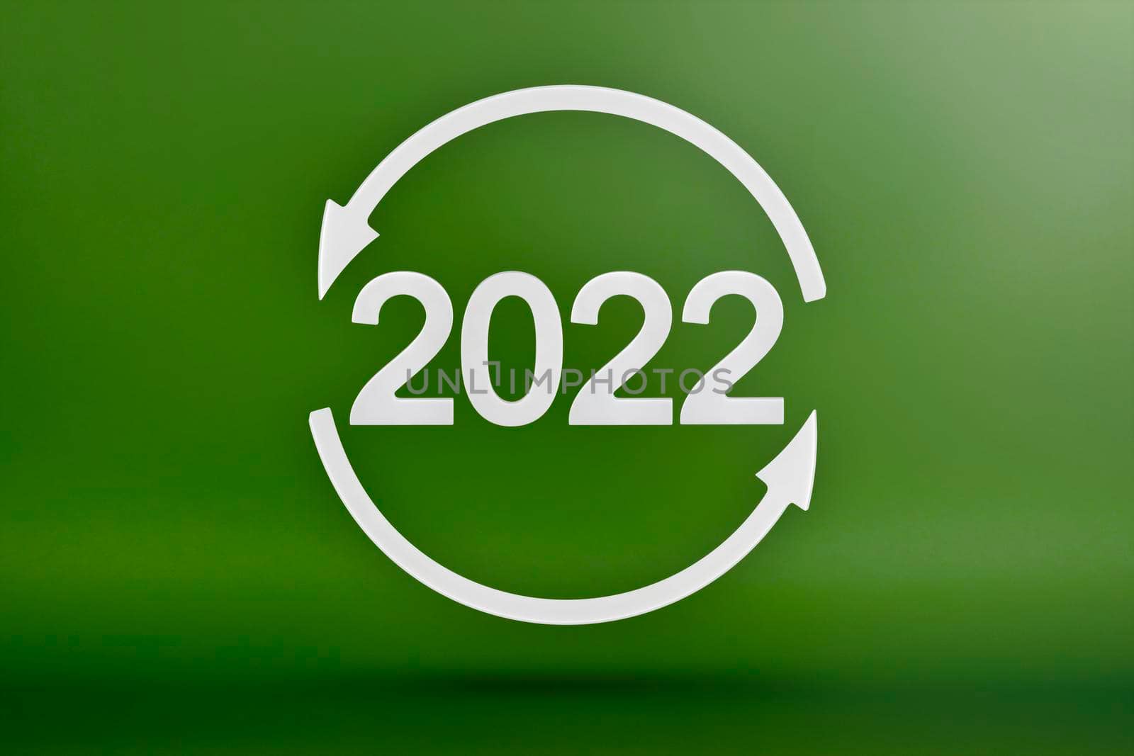 Ecology, recycling symbol 2022, white arrows form a circle. 3D image on a green background. Green products, green renewable energy, graph pointing up and down.