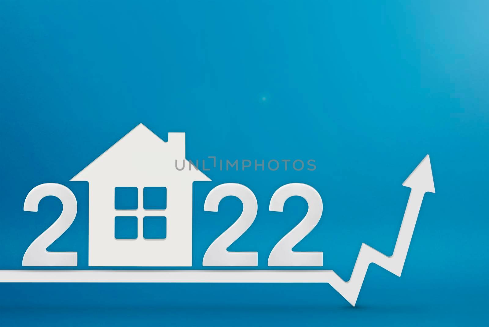 Real estate value in 2022. Rising costs of construction, insurance, rent and mortgages. inflation and rising prices. Model of a house on a blue background. Numbers 2022 on up arrow by SERSOL