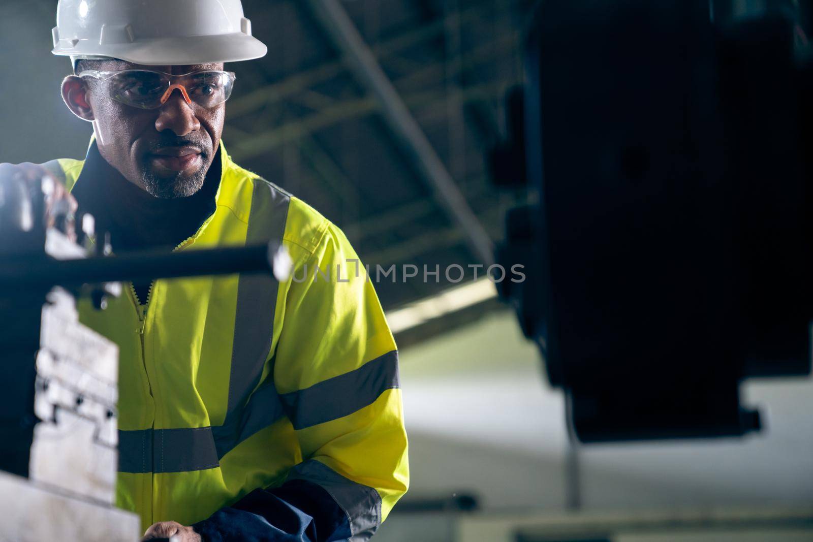 Factory worker or engineer do machine job in adept manufacturing workshop . Industrial people and manufacturing labor concept .