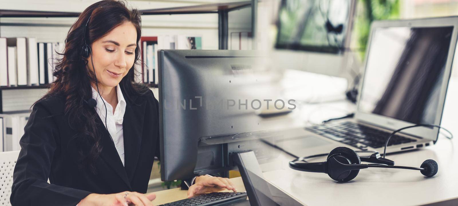 Business people wearing headset working in office broaden view by biancoblue