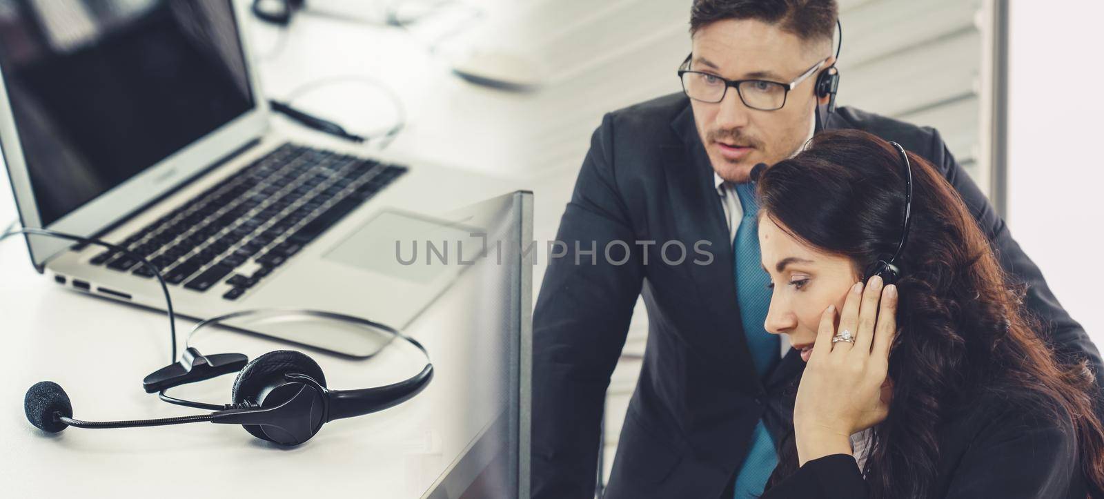 Business people wearing headset working in office broaden view by biancoblue