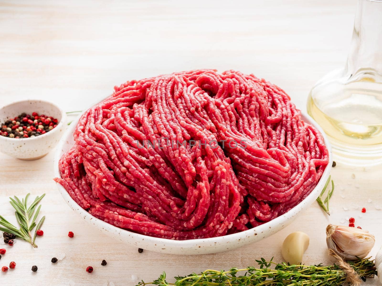 Mince beef, ground meat with ingredients for cooking on dark blue by NataBene